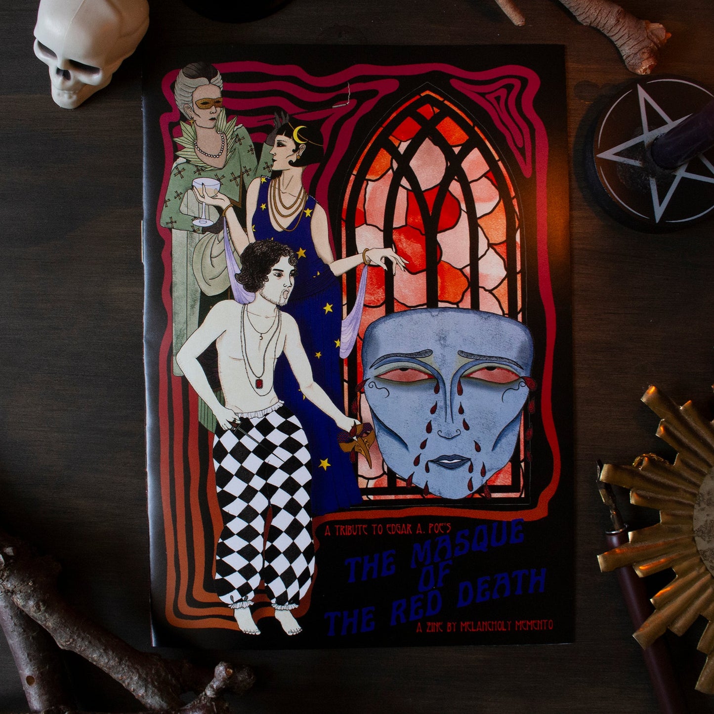 Zine titled 'The Masque of the Red Death' with a stained glass window design on a dark background with three characters from the famous short story.