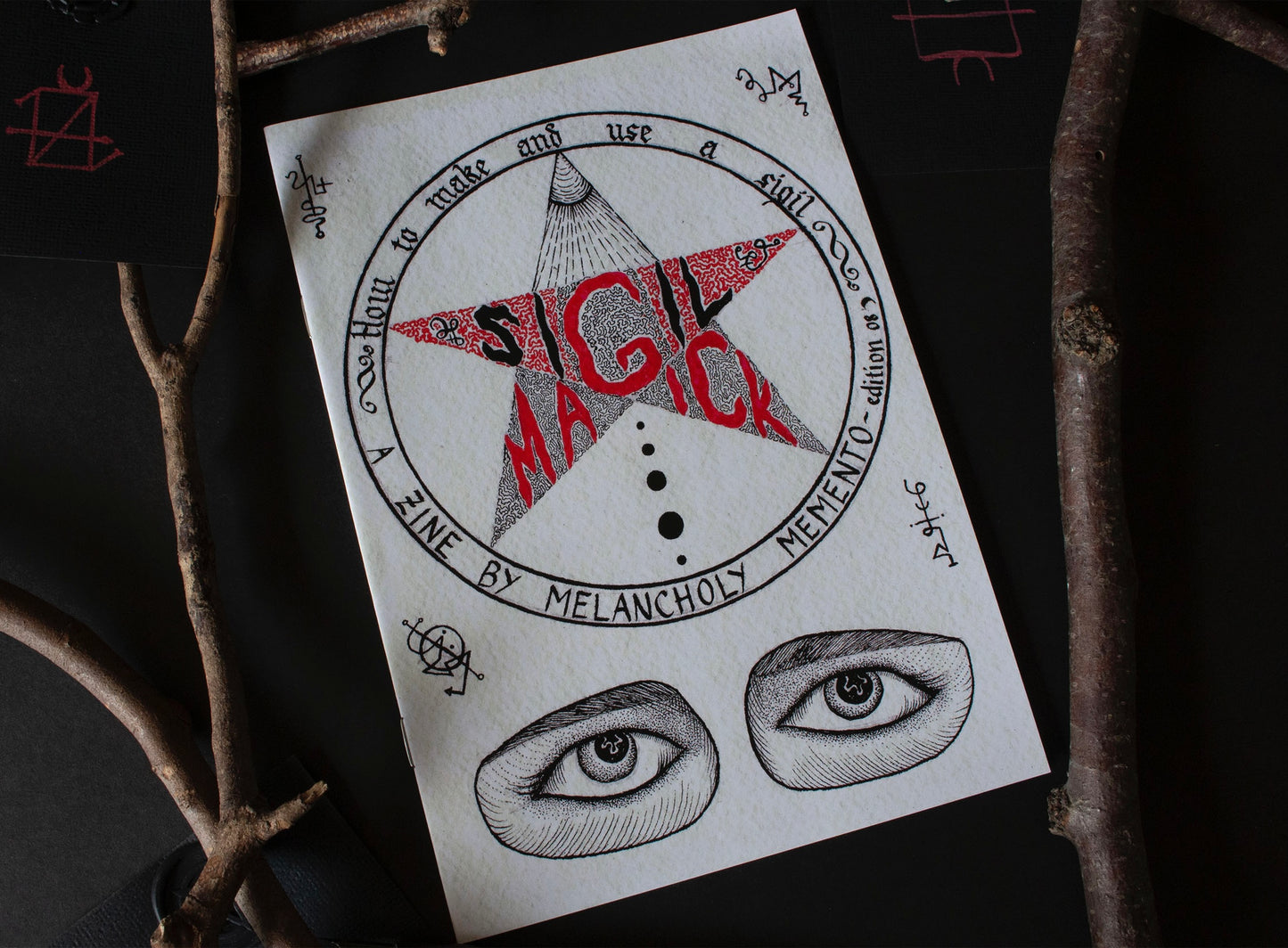 The Sigil Magick Zine surrounded by twigs 